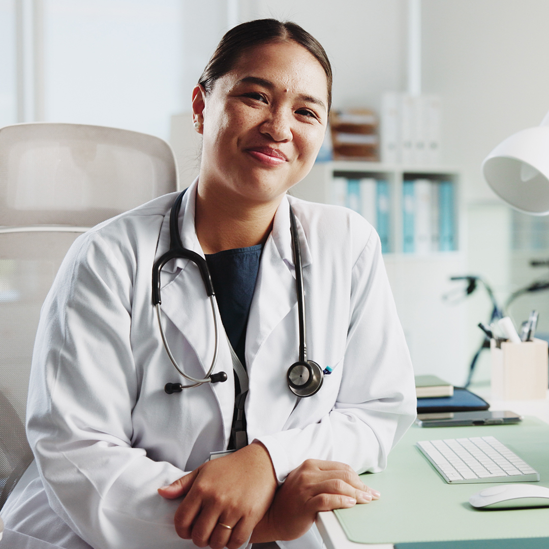 Portrait, happy woman and doctor in clinic, smile and laptop with confidence, career ambition and expert. Face, person or medical with professional, healthcare or stethoscope with specialist or pride.